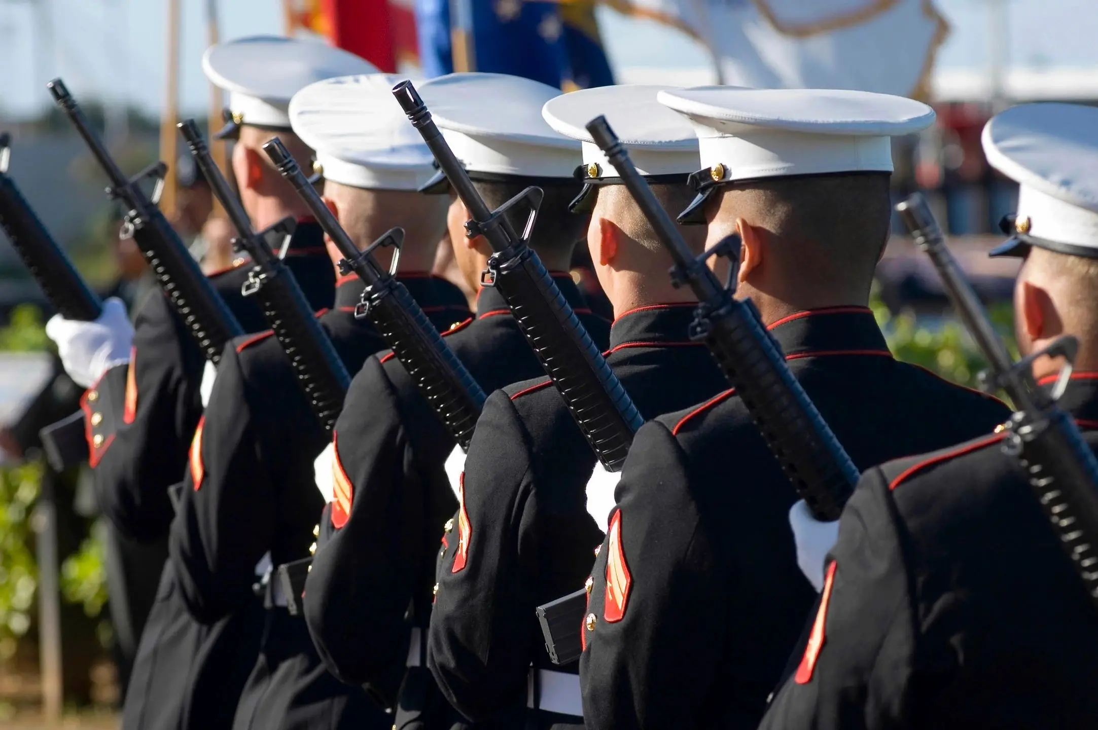 Soldiers in uniform with rifles, lined up.